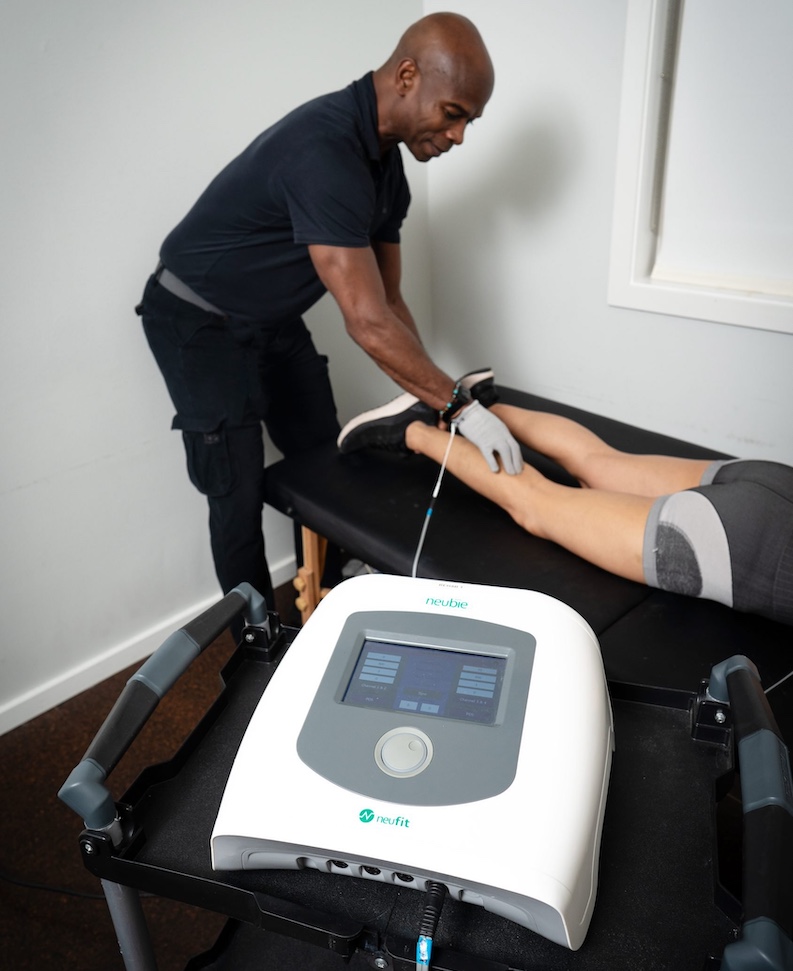 Man using the Neubie device on a patient